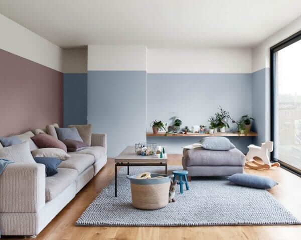 a simple modern living room with soft color maroon and blue color tones