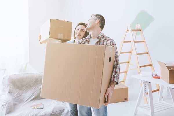 a couple packing their belongings for a move