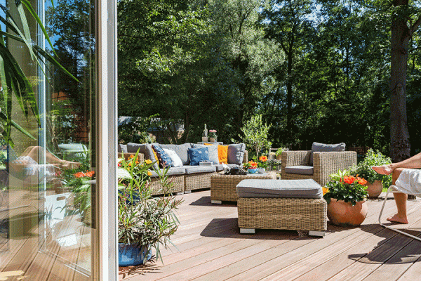 an outdoor living space with furniture and plants