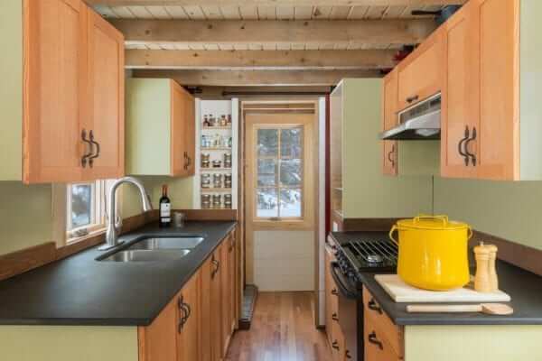 a spacious kitchen with storage cabinets in a tiny home