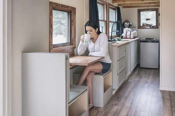 A woman drinking coffee in a tiny home