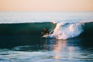 Person surfing in the afternoon